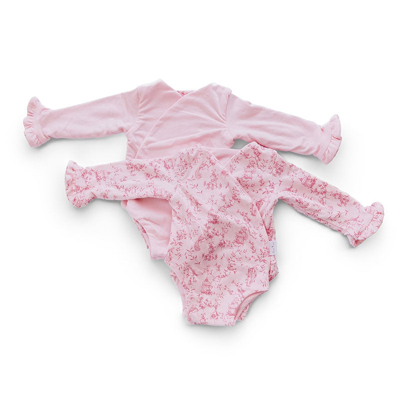 Reversible ruffle cuff long sleeve baby onesie made from bamboo cotton.