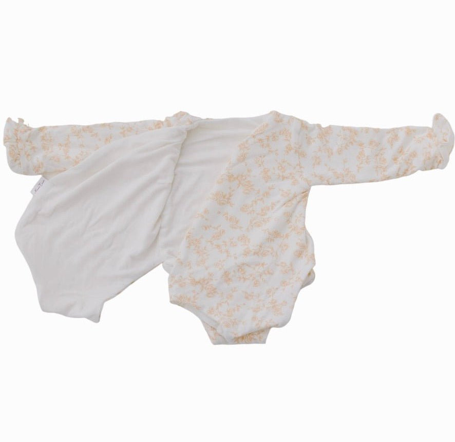 Reversible Bitty Blooms design ruffle cuff long sleeved winged bodysuit in silky modal fabric.