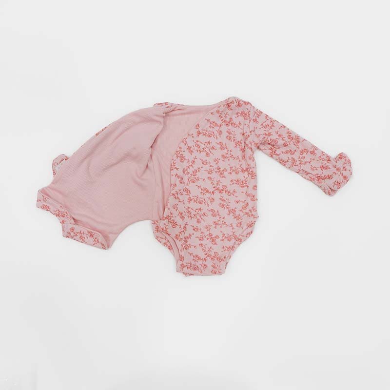 Reversible Bitty Pink Blooms design ruffle cuff long sleeved winged bodysuit in silky modal fabric.