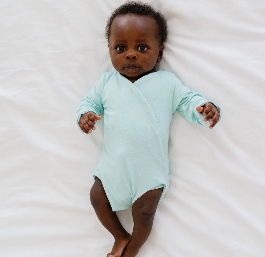 Reversible World Traveler design long sleeved winged bodysuit in classic brushed fabric.