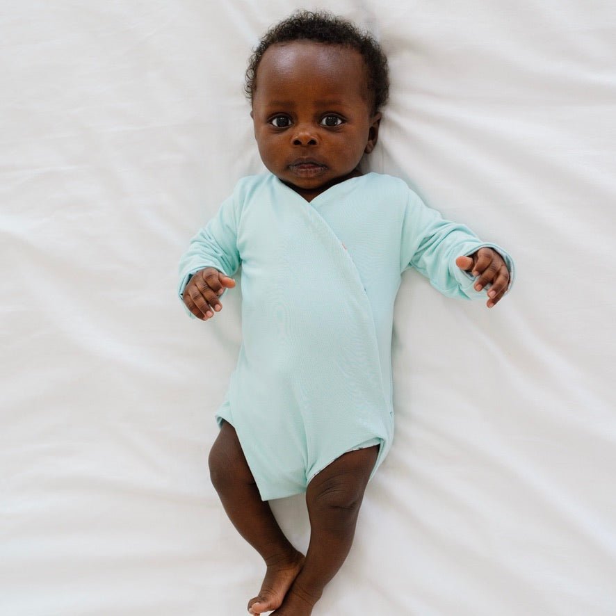 Reversible World Traveler design long sleeved winged bodysuit in classic brushed fabric.