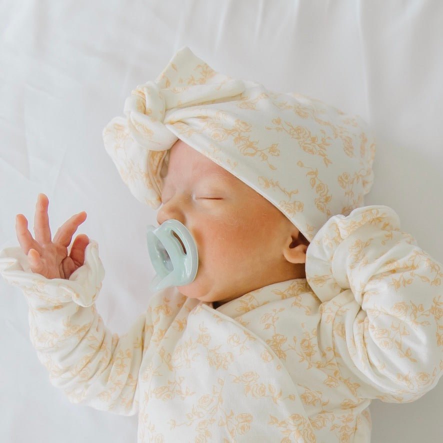 Ruched baby beanies with bows crafted in soft Bitty Blooms design Silky Modal fabric.