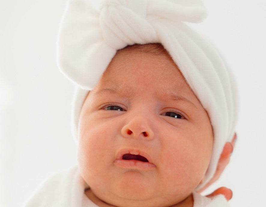 Ruched beanie with bow crafted in soft Plush Perfection design Plush Dream fabric.