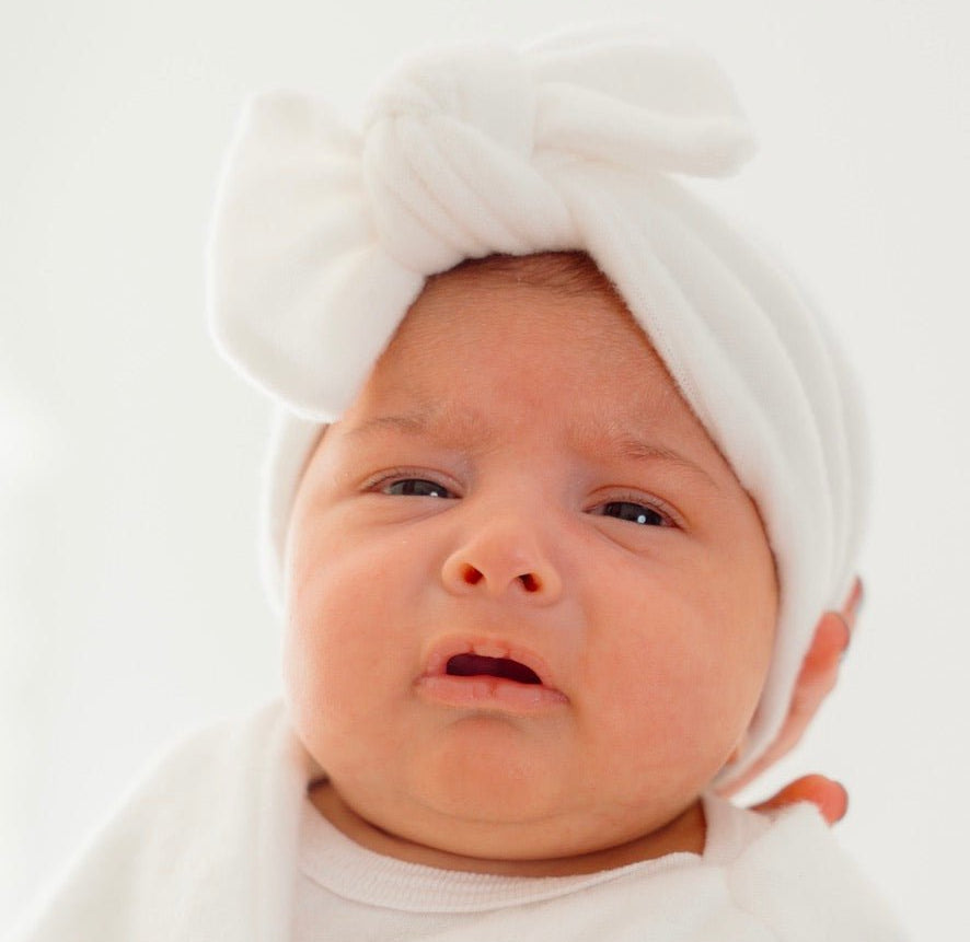 Ruched beanie with bow crafted in soft Plush Perfection design Plush Dream fabric.