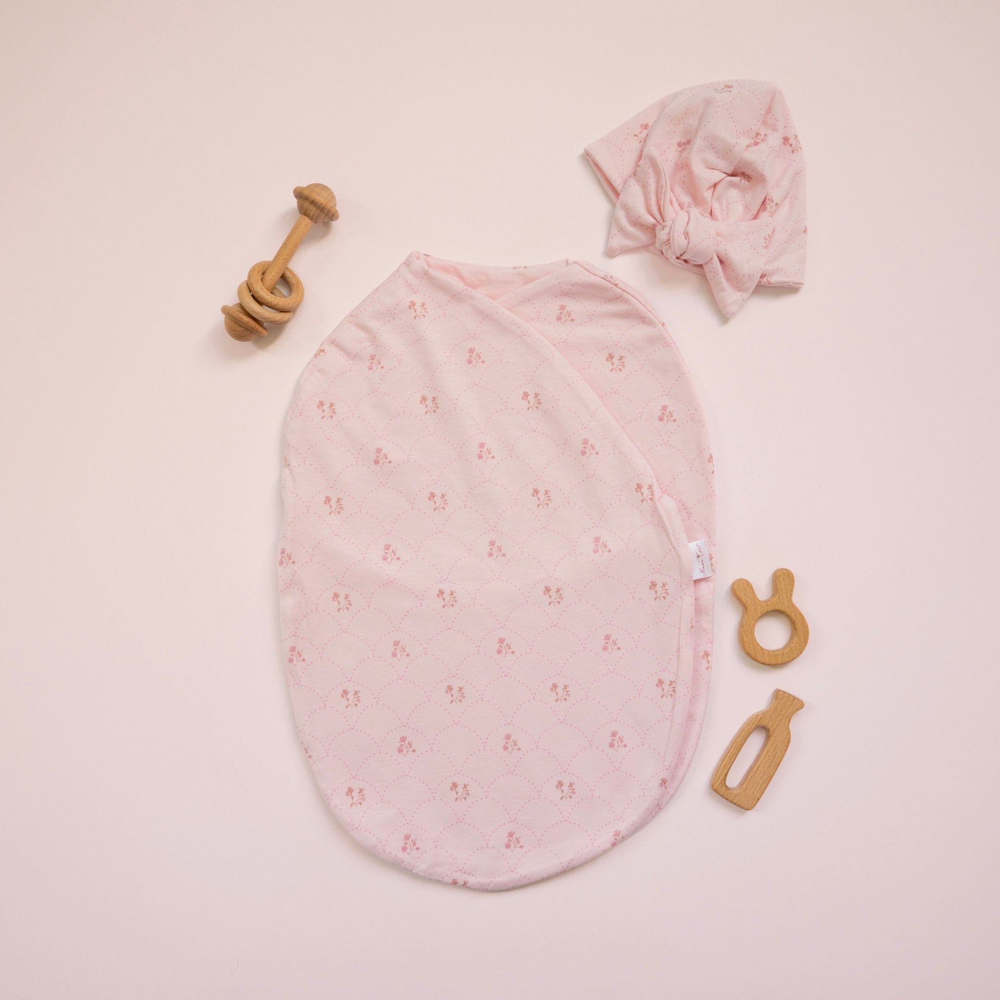 Bamboo cotton baby beanie with ruched bow in dainty dots design. Shown with matching cocoon swaddle.