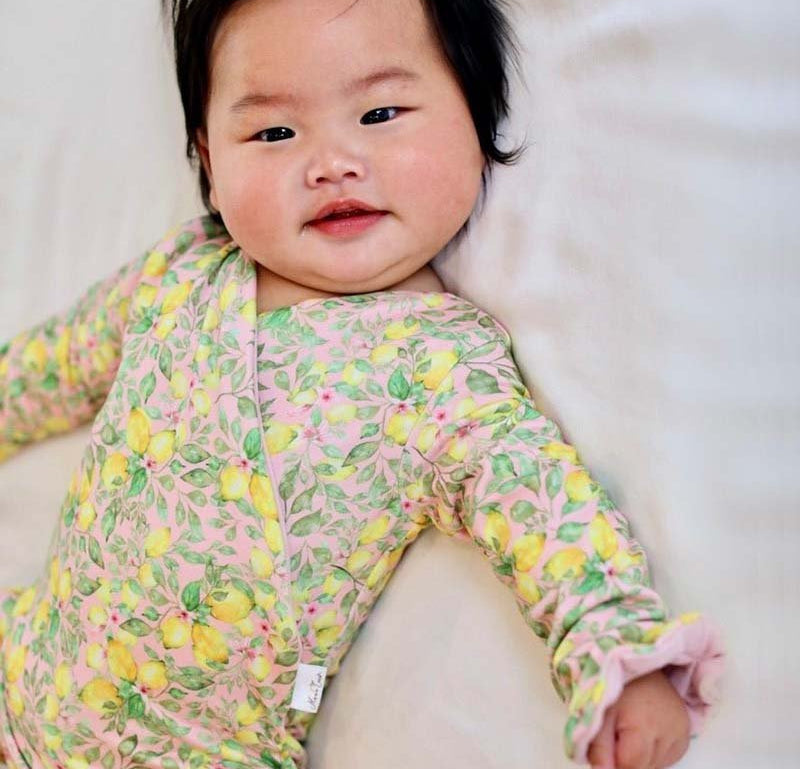 Ruffle cuff baby bodysuit with wings in Pink Lemonade design classic brushed fabric.