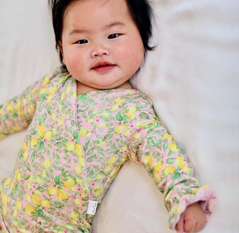 Ruffle cuff baby bodysuit with wings in Pink Lemonade design classic brushed fabric.