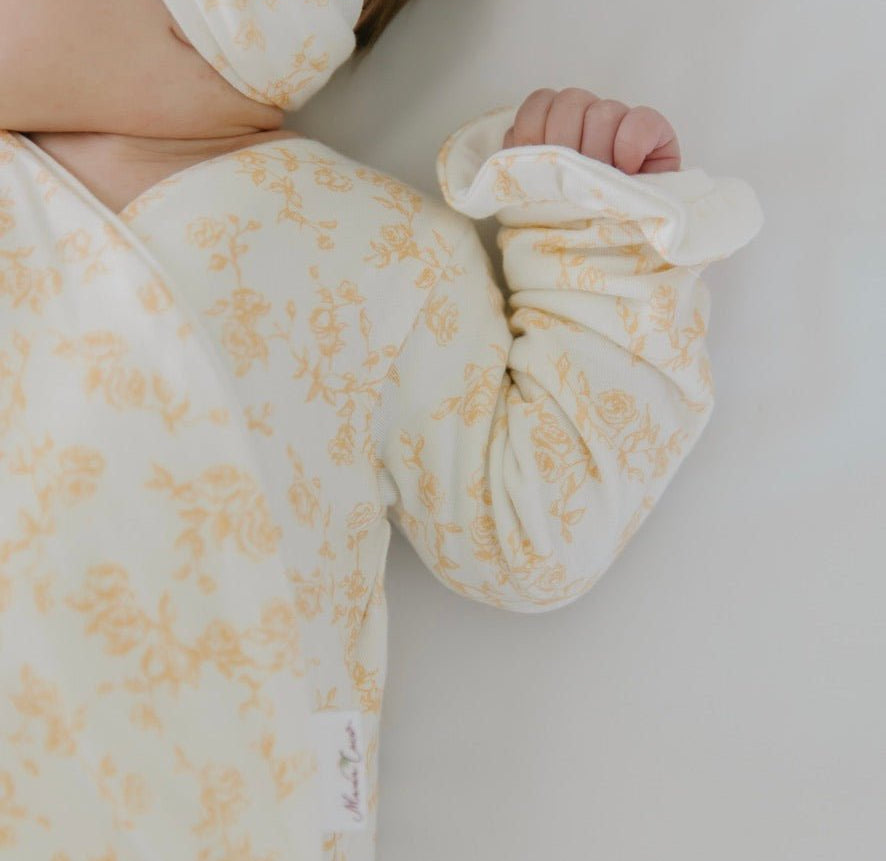 Long sleeved winged bodysuit for babies in silky modal fabric with ruffle cuffs.
