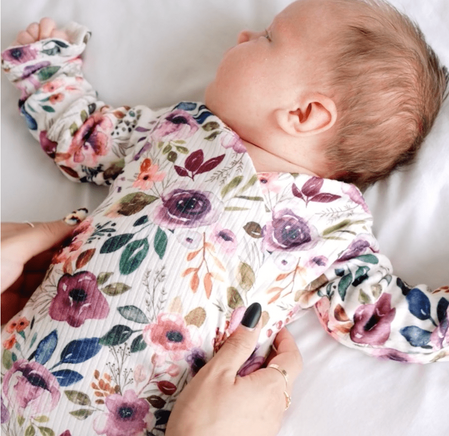 Ivory wildflowers ruffle cuff long sleeve onesie.