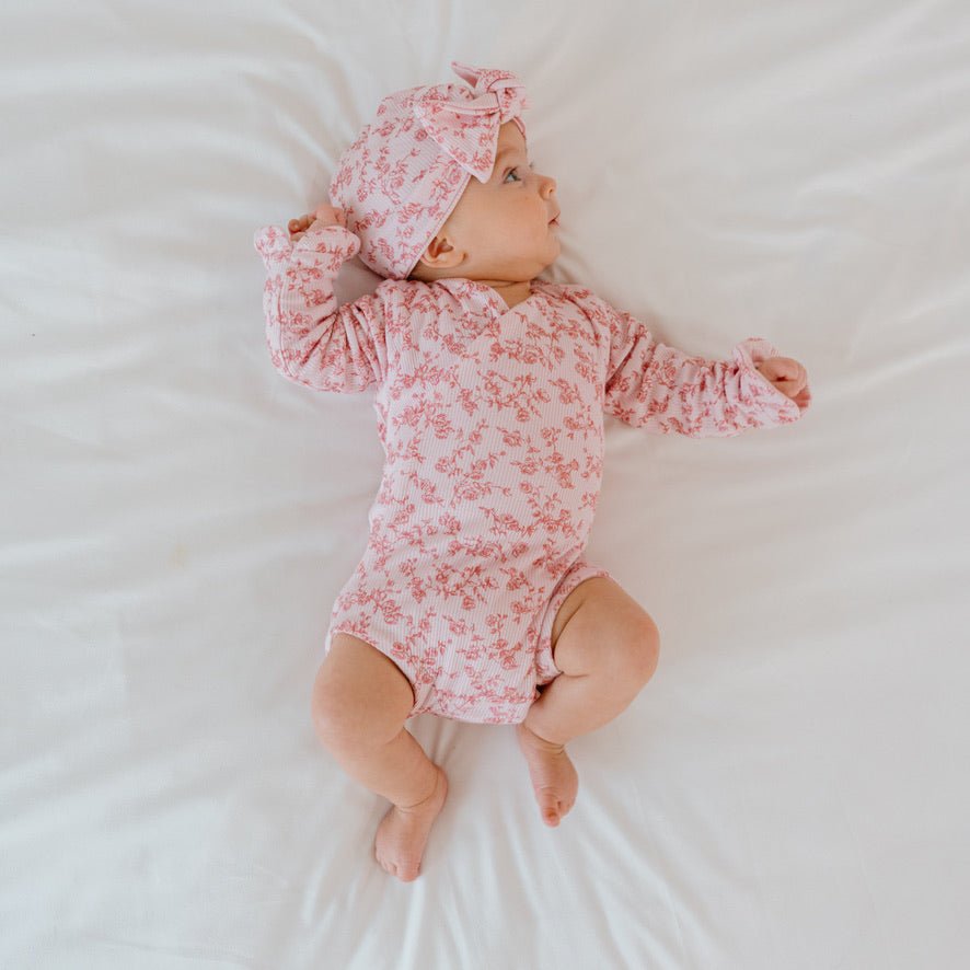 Ruffle cuff long sleeve baby onesie outfit bundle made from silky modal fabric in bitty pink blooms design.