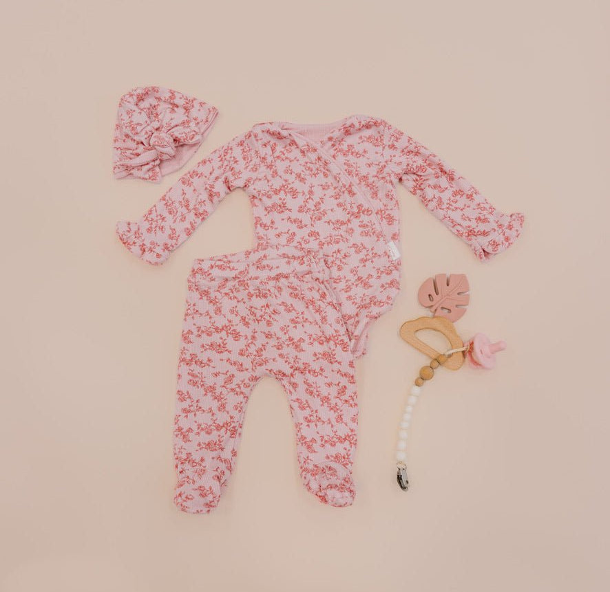 Ruffle cuff long sleeve baby onesie outfit bundle made from silky modal fabric in bitty pink blooms design.