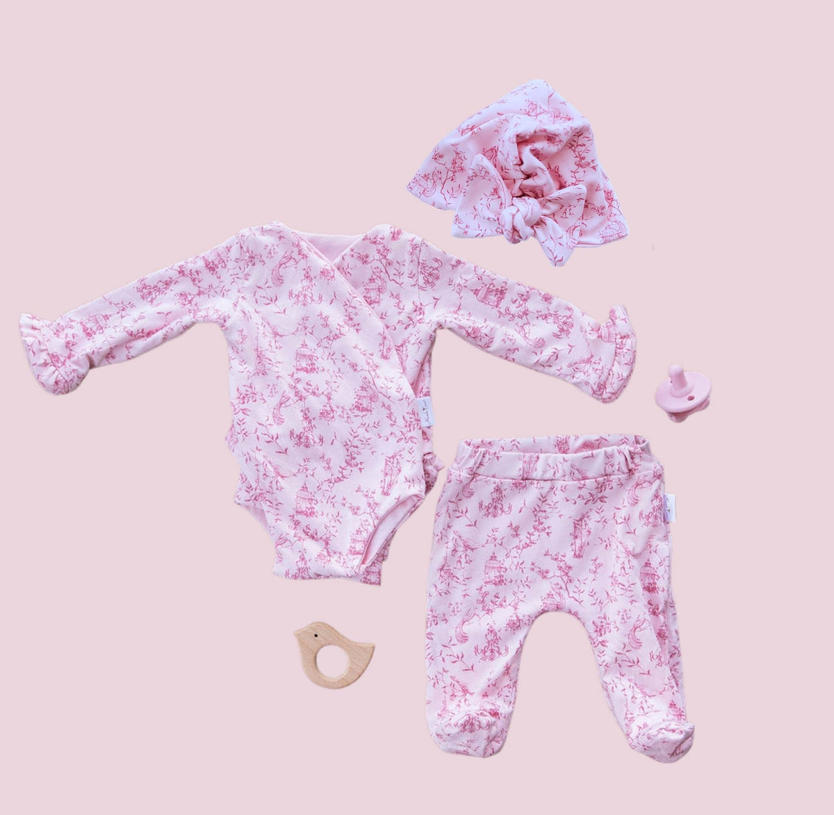 Long-sleeve ruffle cuff baby onesie outfit bundle made from bamboo cotton in whimsical garden design.