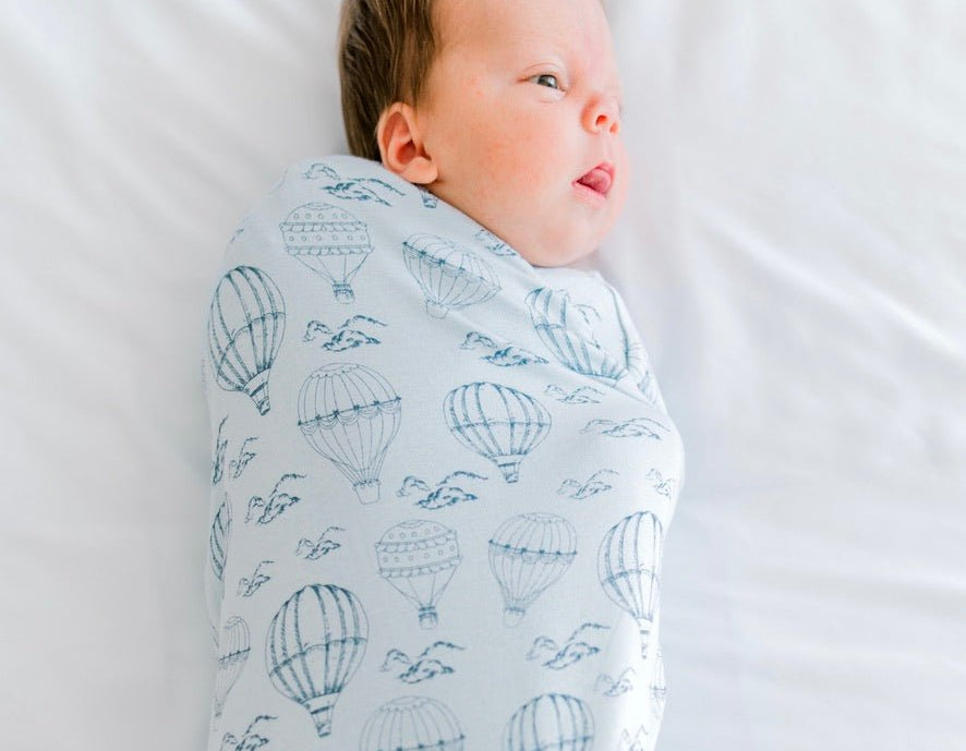 Classic brushed newborn essentials bundle featuring a long sleeve top with ruffle cuffs in bon voyage design.