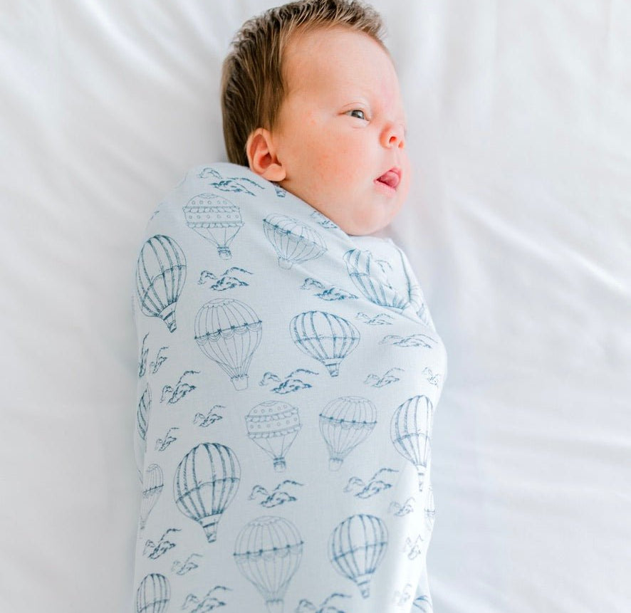 Classic brushed newborn essentials bundle featuring a long sleeve top with ruffle cuffs in bon voyage design.
