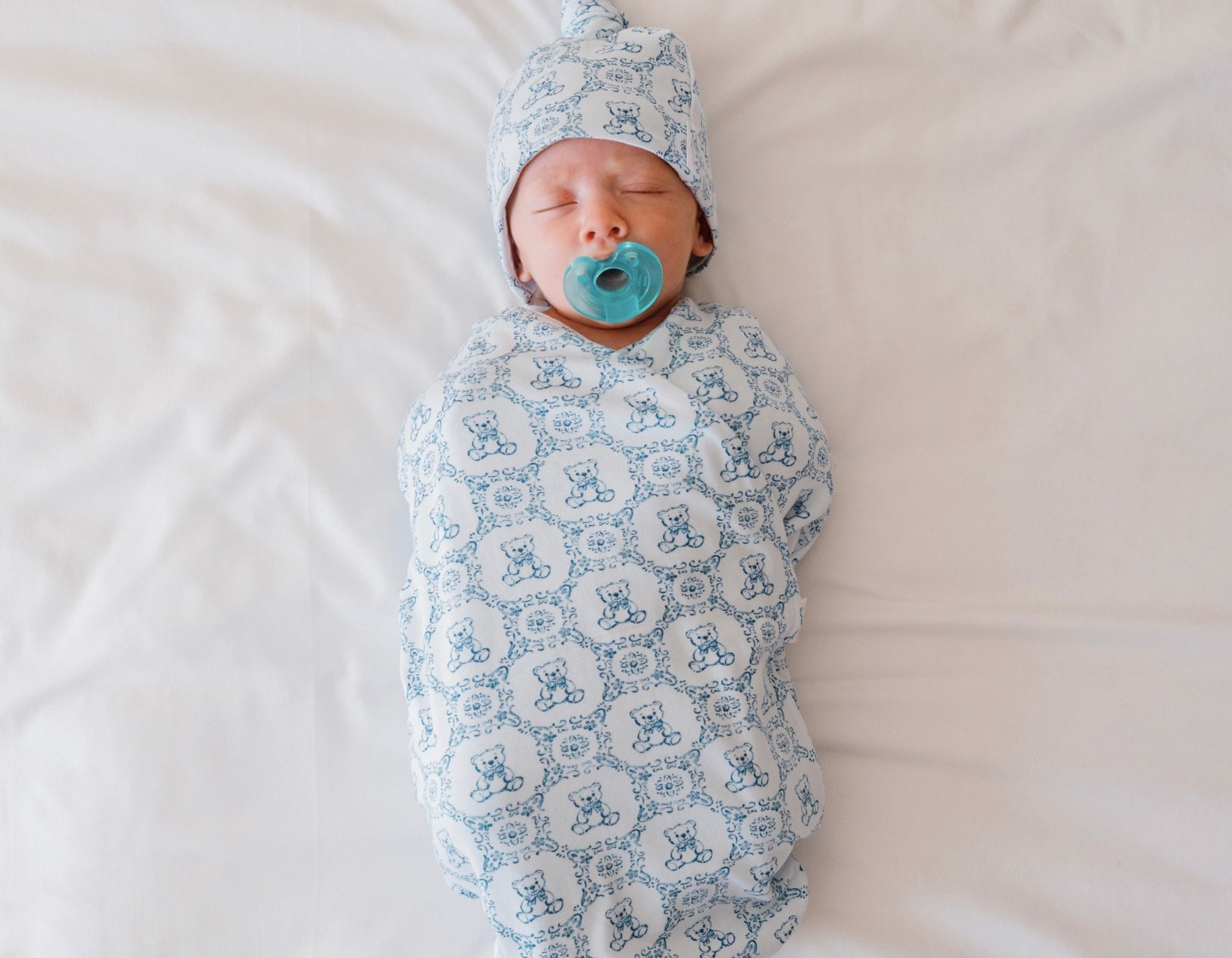 Classic brushed newborn essentials bundle featuring a long sleeve top with ruffle cuffs in teddy tiles design.