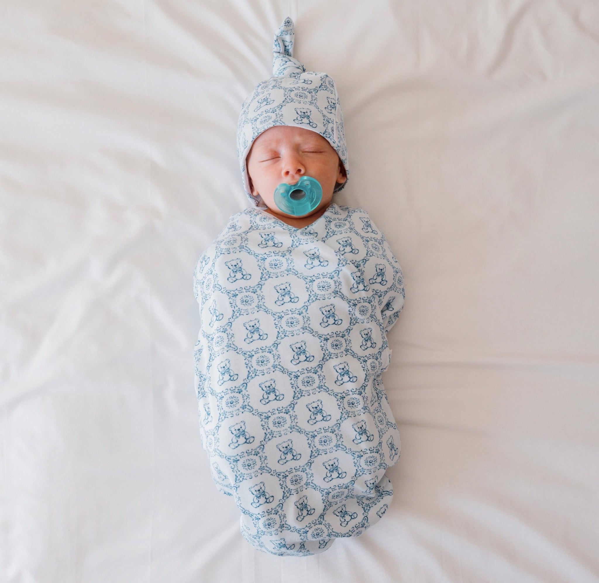 Classic brushed newborn essentials bundle featuring a long sleeve top with ruffle cuffs in teddy tiles design.