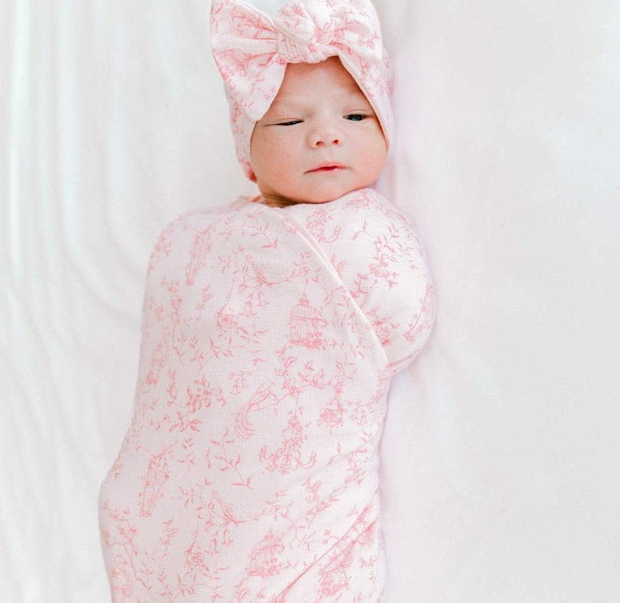 Classic brushed newborn essentials bundle featuring a long sleeve top with ruffle cuffs in whimsical garden design.