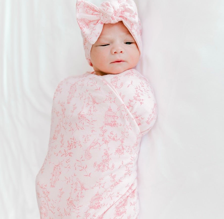 Classic brushed newborn essentials bundle featuring a long sleeve top with ruffle cuffs in whimsical garden design.