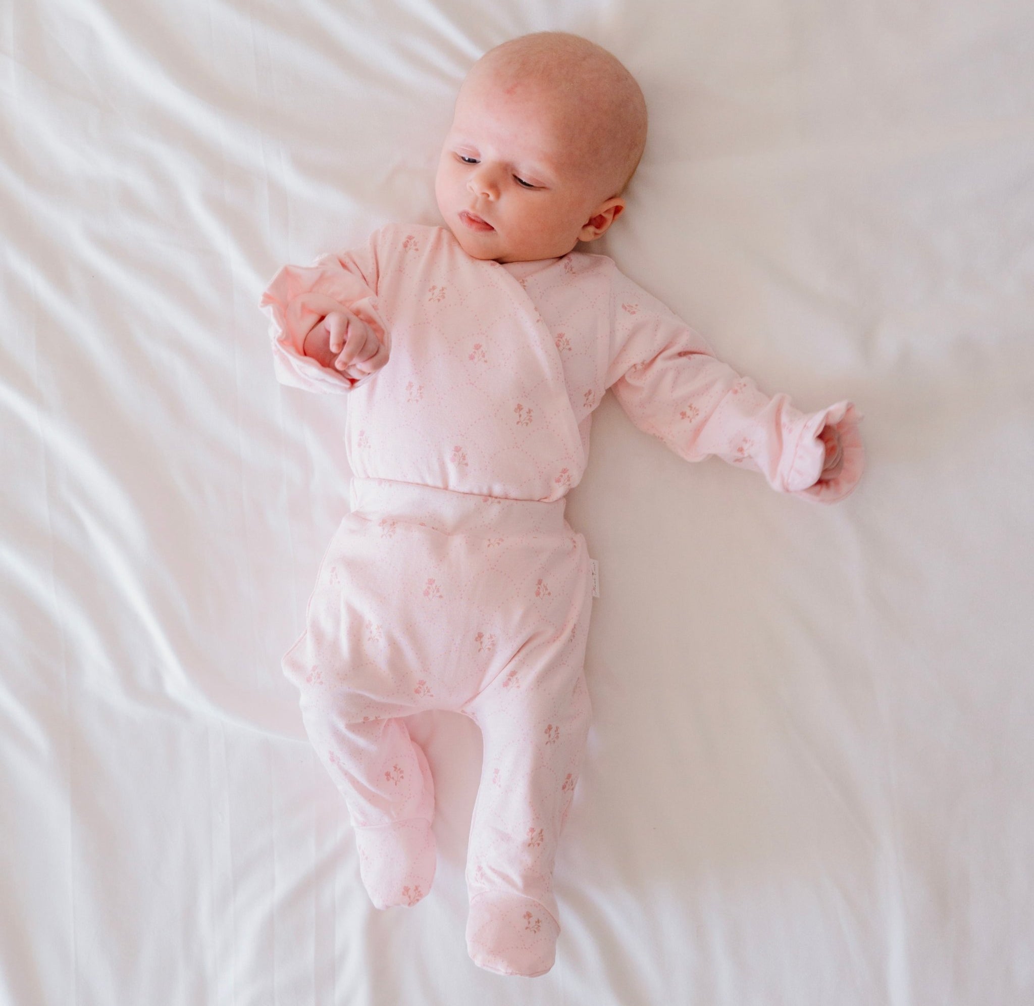 Long-sleeve baby ruffle cuff onesie outfit bundle made from bamboo cotton in dainty dots design.