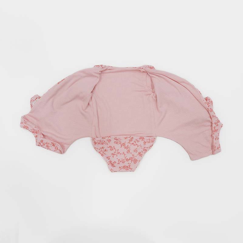 Reversible long sleeved winged bodysuit for babies in silky modal fabric with ruffle cuffs.