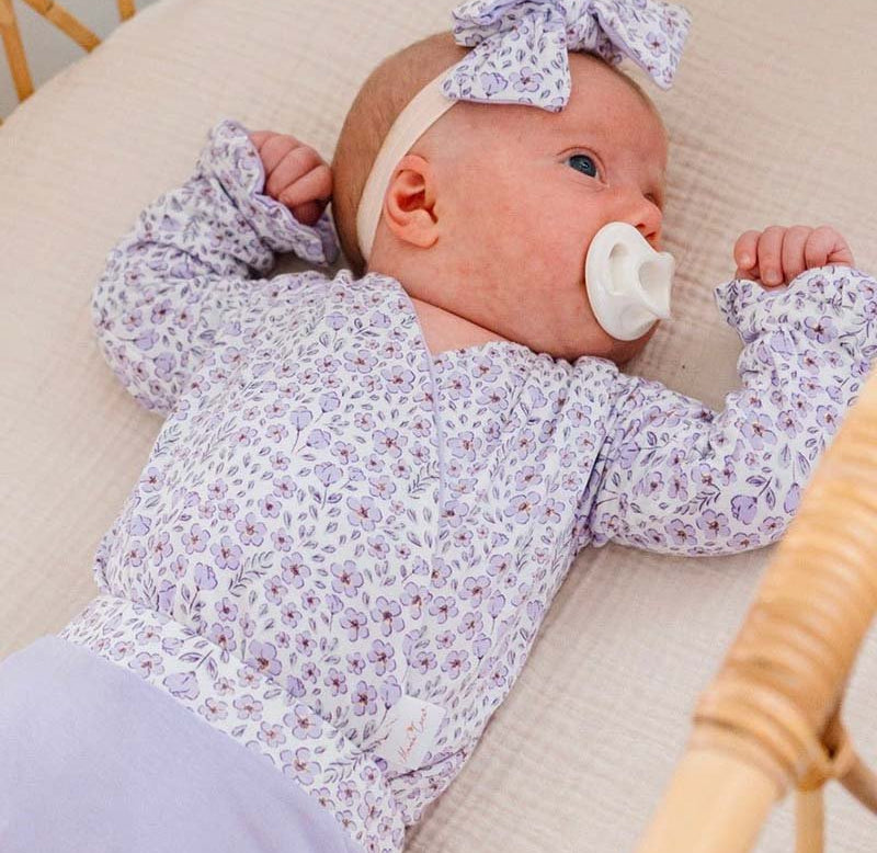 Purple Posies design ruffle cuff baby winged bodysuit in silky modal fabric.