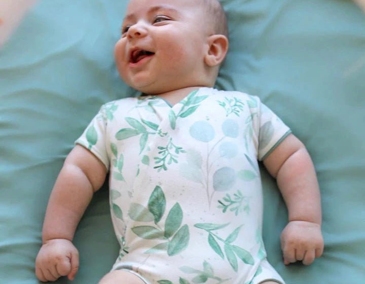 Saged eucalyptus design short-sleeve baby onesie in classic brushed fabric.