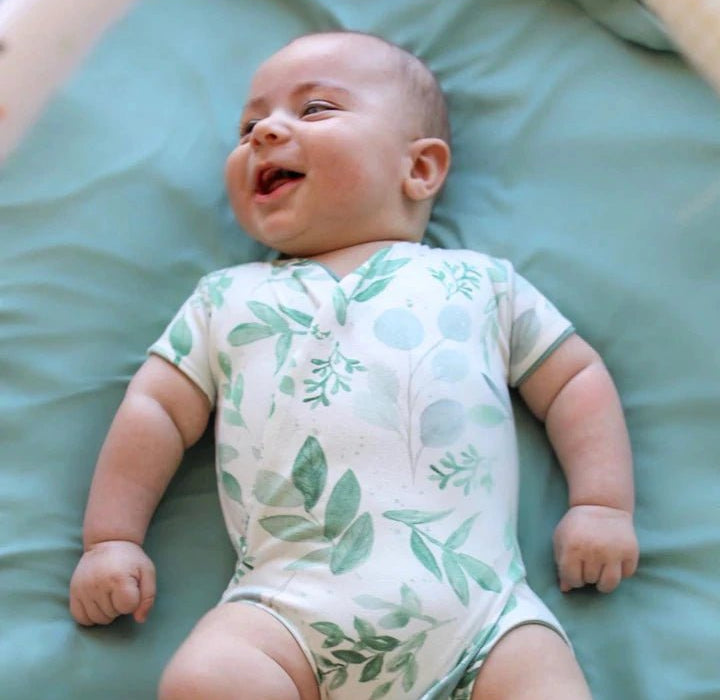 Saged eucalyptus design short-sleeve baby onesie in classic brushed fabric.