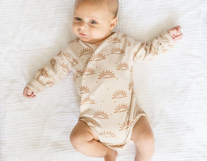 Sandy sunsets design long-sleeve baby onesie in classic brushed fabric.