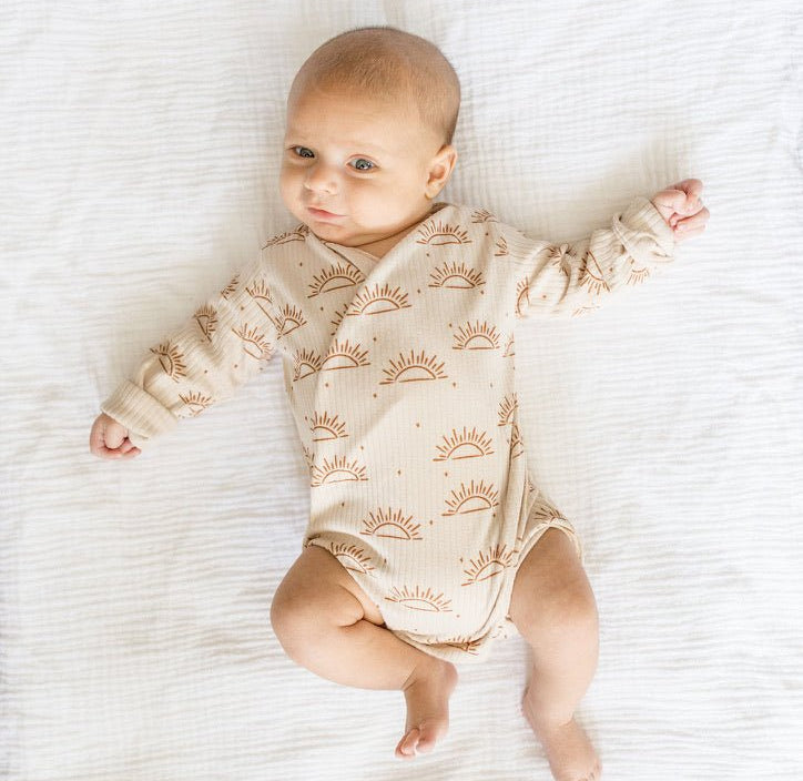 Sandy sunsets design long-sleeve baby onesie in classic brushed fabric.