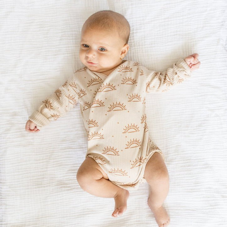 Sandy sunsets design long-sleeve baby onesie in classic brushed fabric.