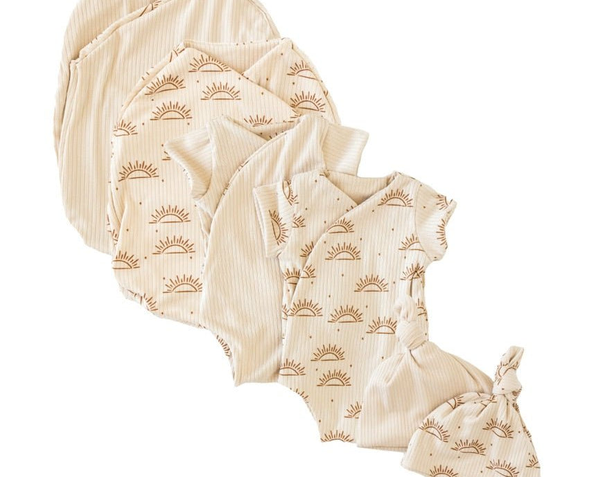 Newborn essentials bundle with short sleeves in classic brushed fabric with sandy sunsets design.