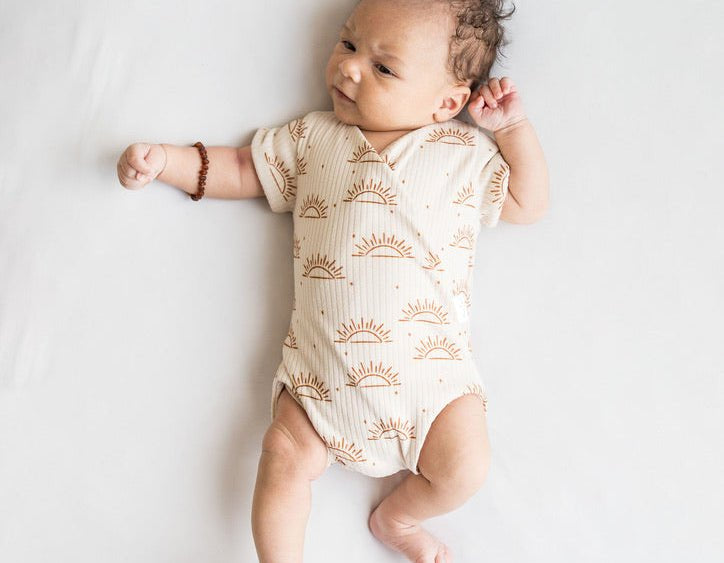 Sandy sunsets design short-sleeve baby onesie in classic brushed fabric.