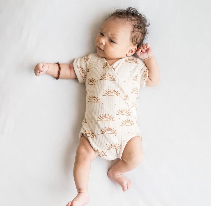 Sandy sunsets design short-sleeve baby onesie in classic brushed fabric.