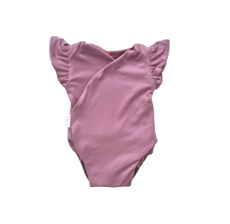 Reversible Peachy Lilac short-sleeve baby bodysuit in Classic Brushed fabric styles.