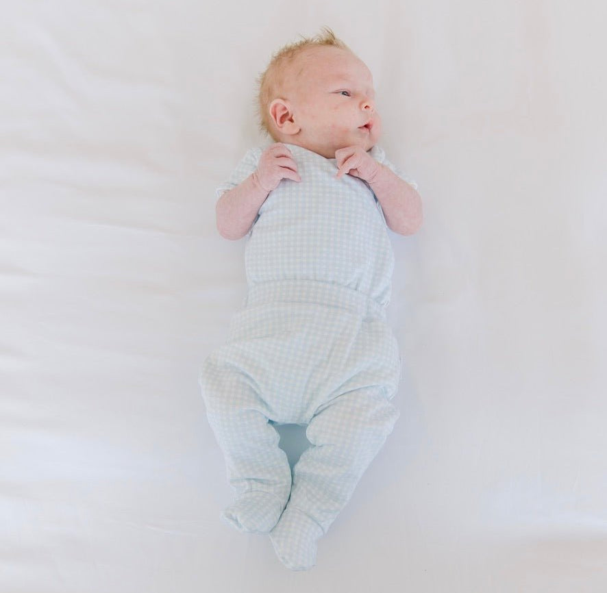 Reversible short-sleeve baby winged bodysuit and footie pants in baby blue gingham design.