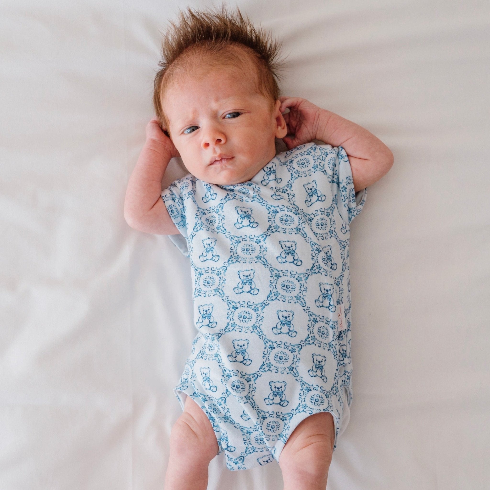 Short-sleeve baby onesie outfit bundle made from bamboo cotton in teddy tiles design.