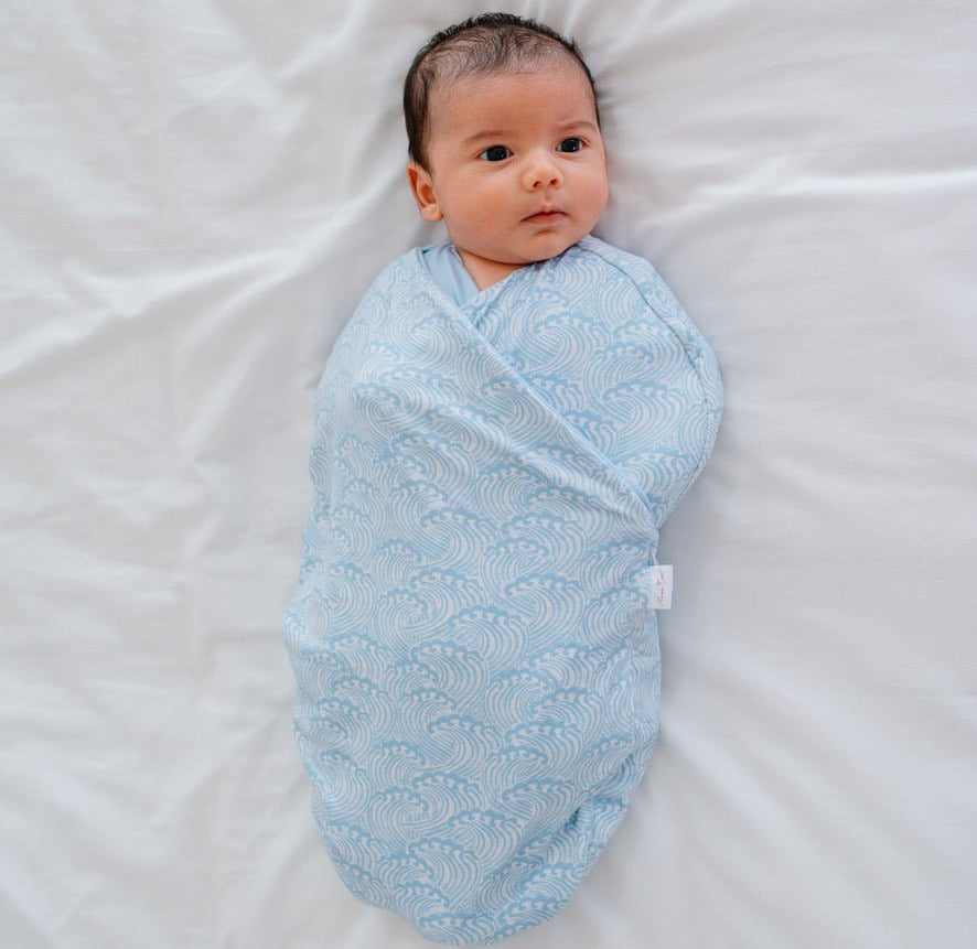 Soft baby cocoon swaddle made from Silky Modal in the Blue Swells design.