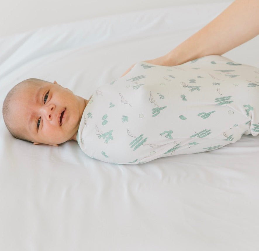 Soft baby cocoon swaddle made from Silky Modal in the Desert Sunsets design.