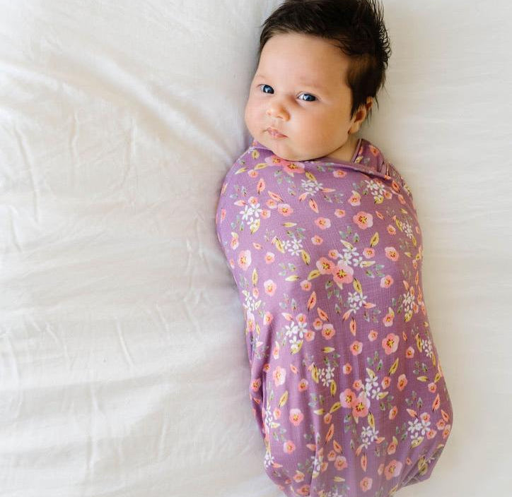 Soft baby cocoon swaddle made from Silky Modal in Peachy Lilac design.