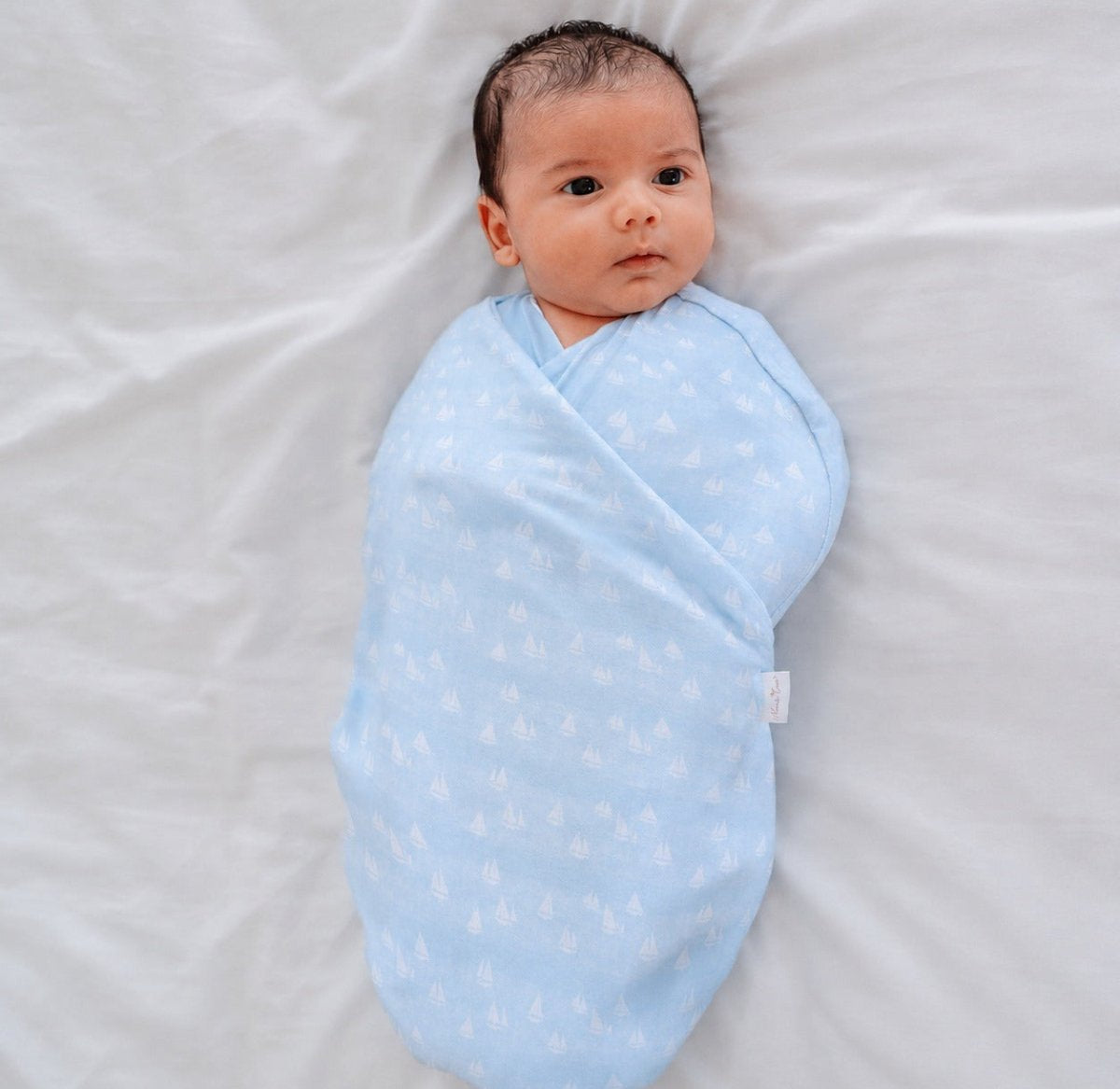 Soft baby cocoon swaddle made from Silky Modal in the Sailboat Shores design.