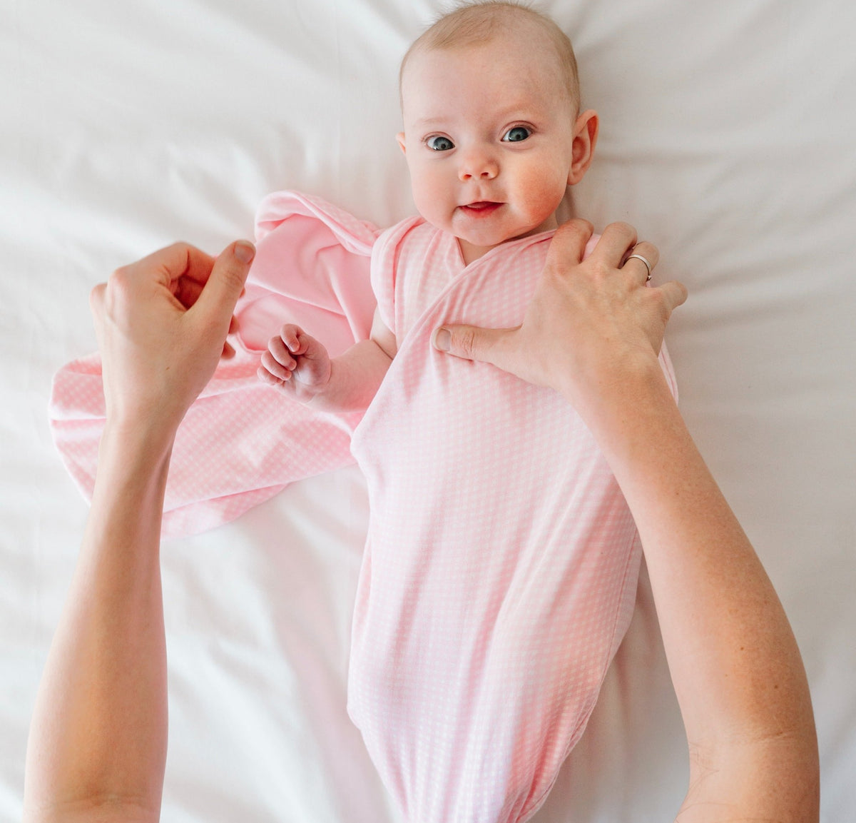 Soft Baby Pink Gingham design on a Cocoon swaddle blanket in Silky Modal fabric styles.