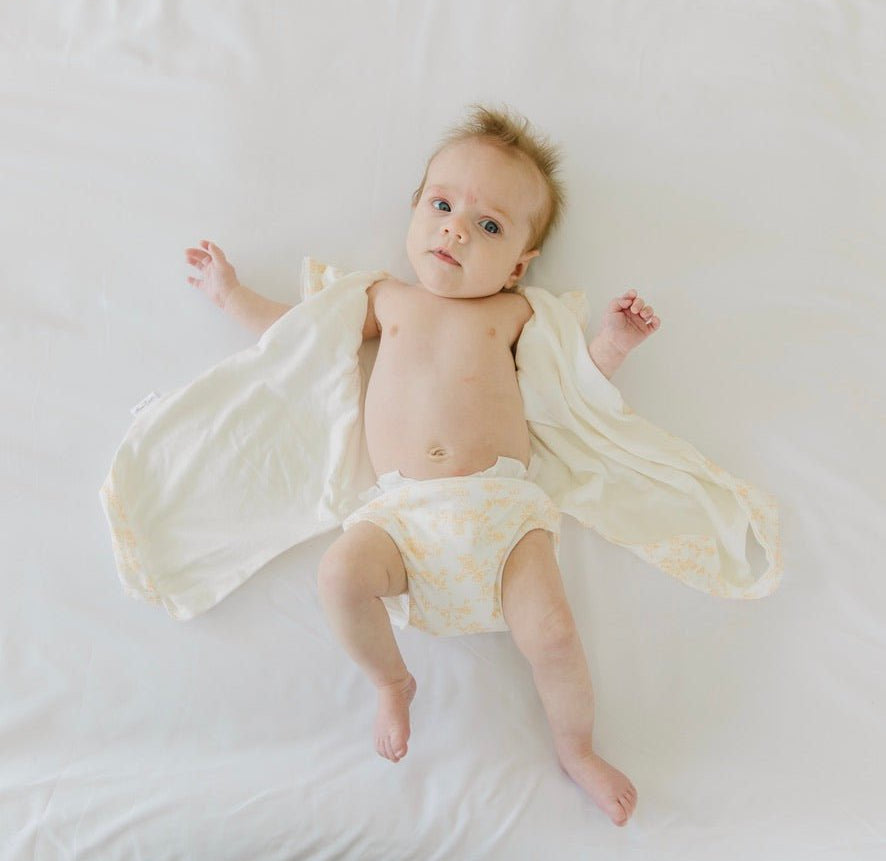 Bitty Blooms design flutter sleeve winged bodysuit for babies in silky modal fabric.