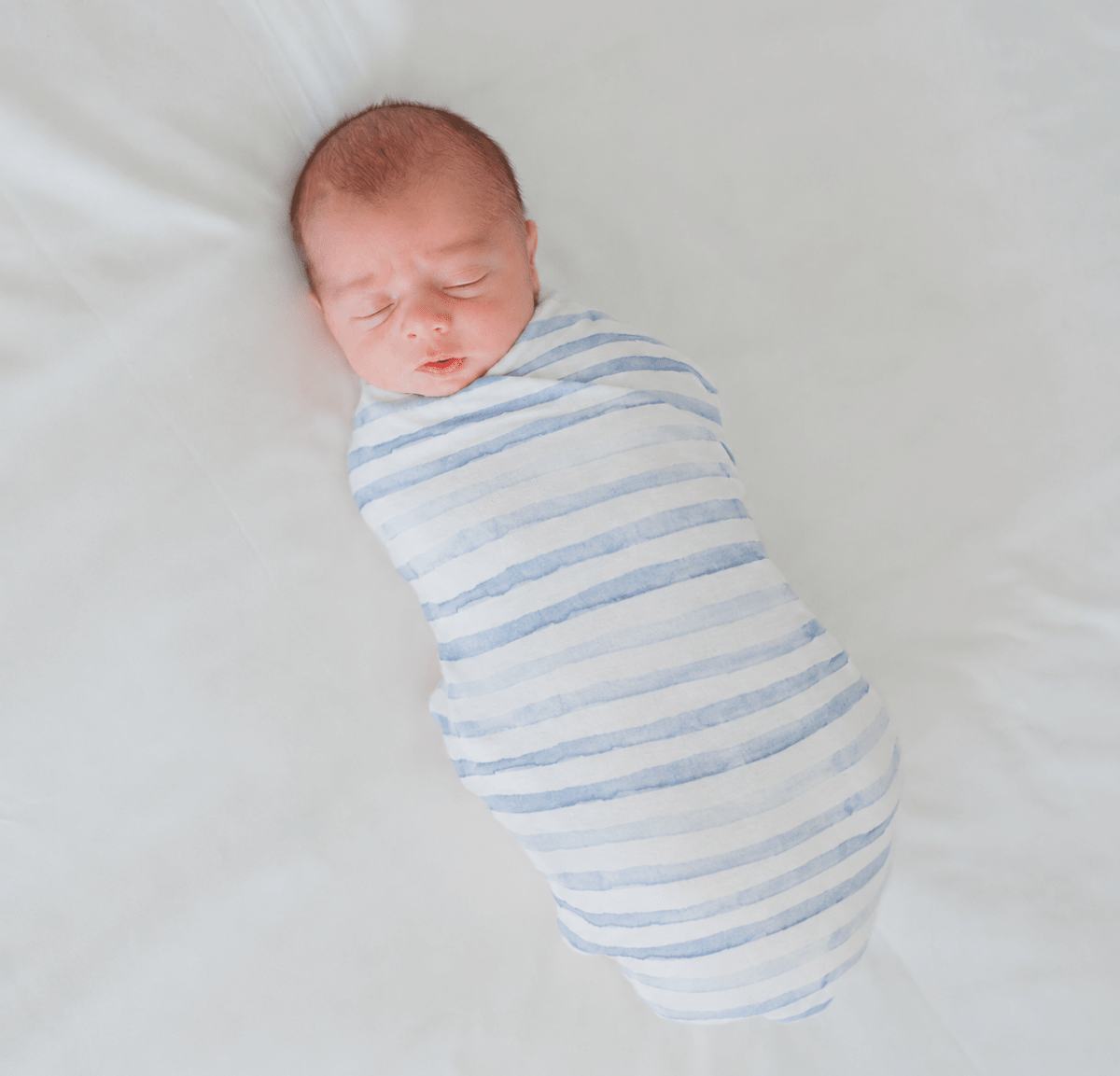Soft baby cocoon swaddle made from Silky Modal in the Chambray Waves design.