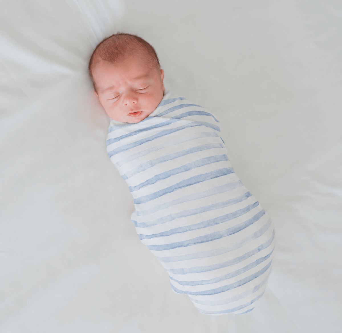 Soft baby cocoon swaddle made from Silky Modal in the Chambray Waves design.