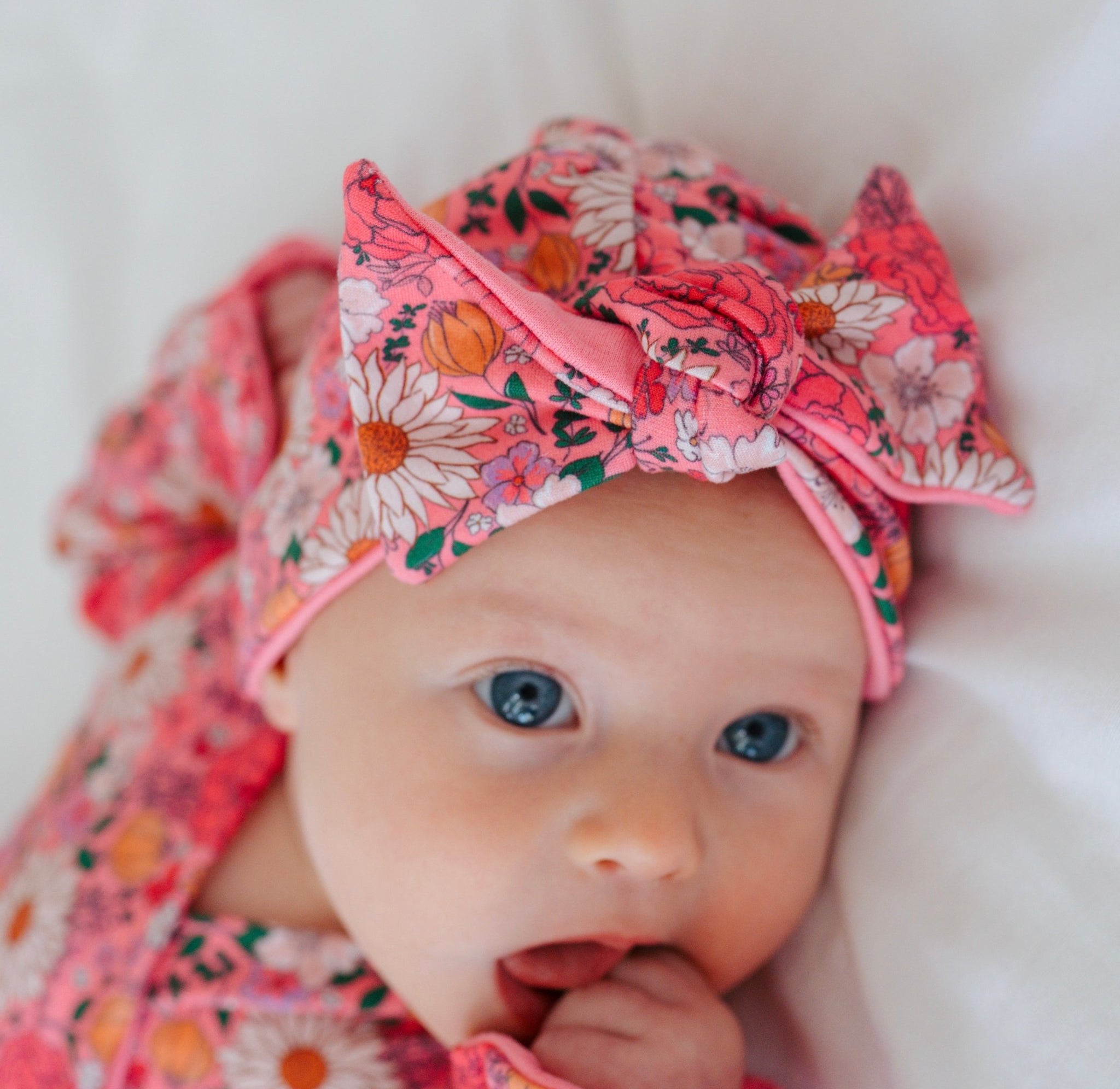 Cozy ruched beanie with bow for babies featuring the gentle Flower Power print.