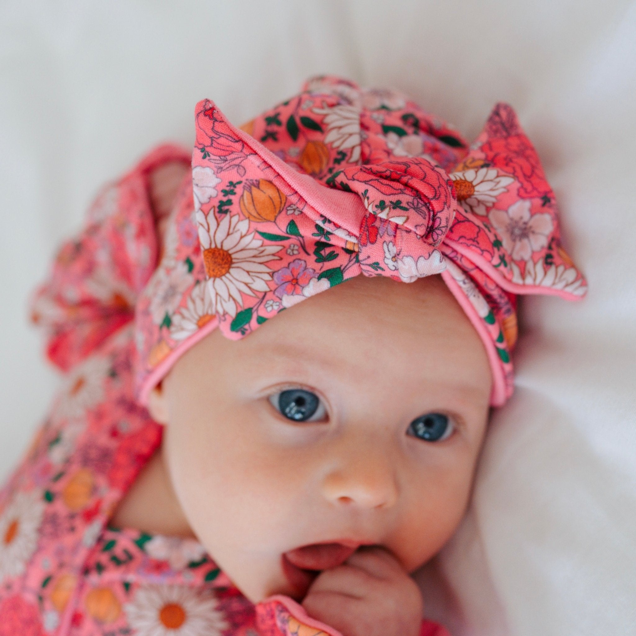 Cozy ruched beanie with bow for babies featuring the gentle Flower Power print.