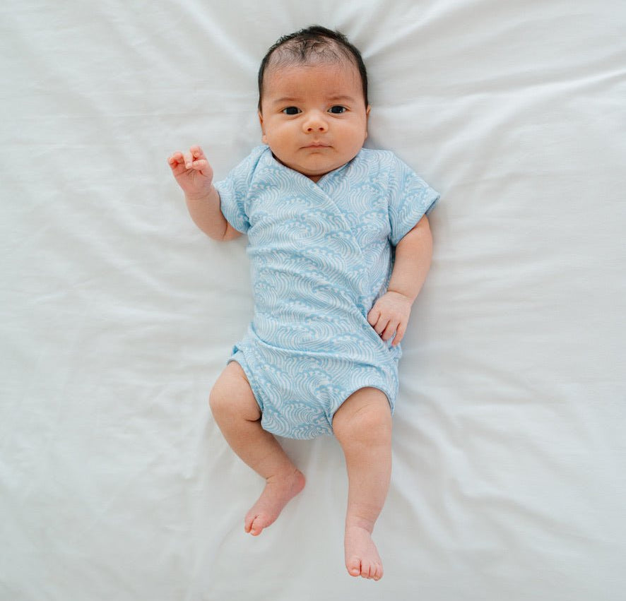 Short-sleeve winged bodysuit featuring the Blue Swells print in cozy classic brushed fabric.