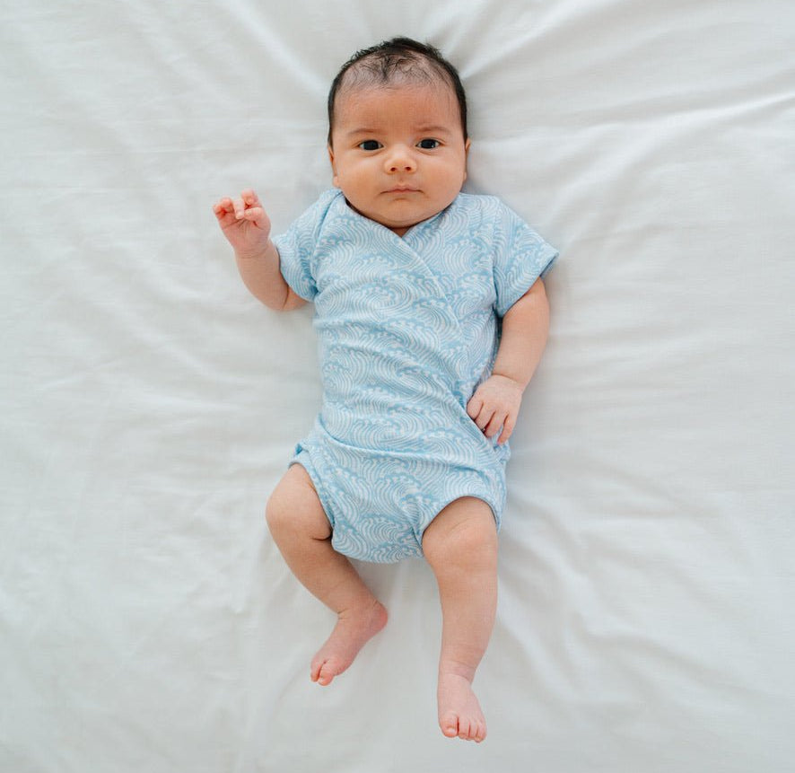 Short-sleeve winged bodysuit featuring the Blue Swells print in cozy classic brushed fabric.