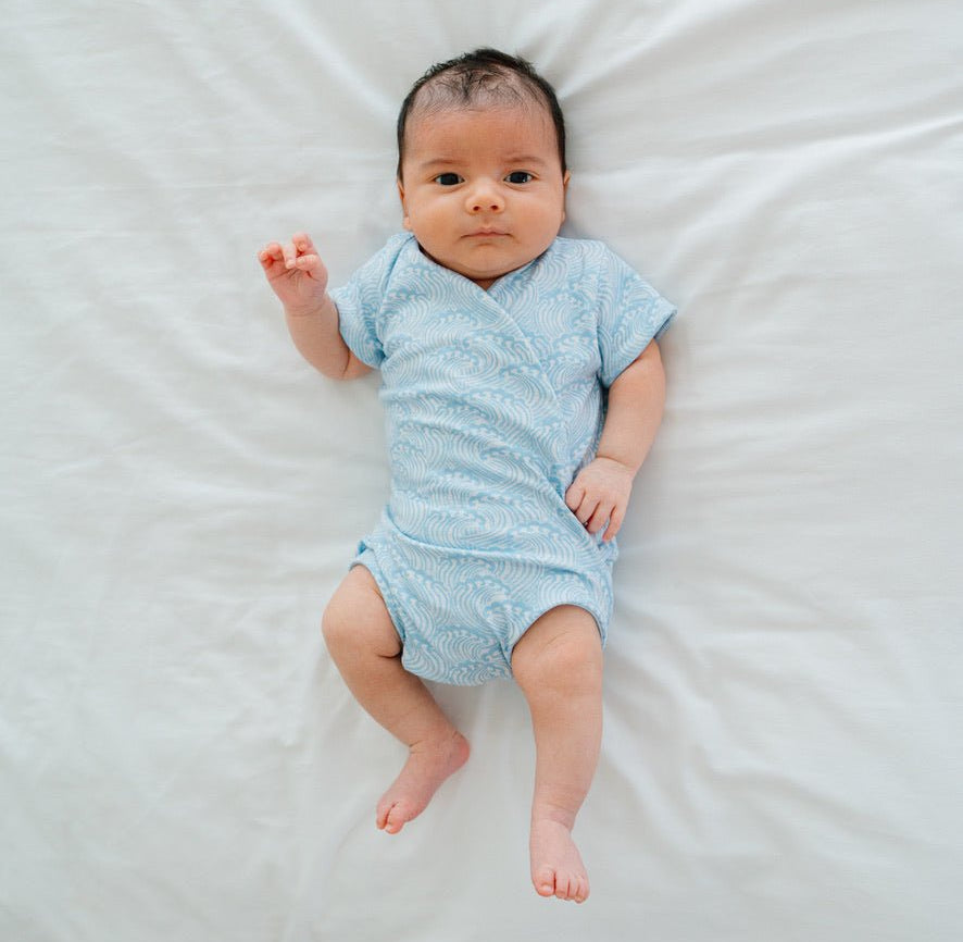 Short-sleeve winged bodysuit featuring the Blue Swells print in cozy classic brushed fabric.