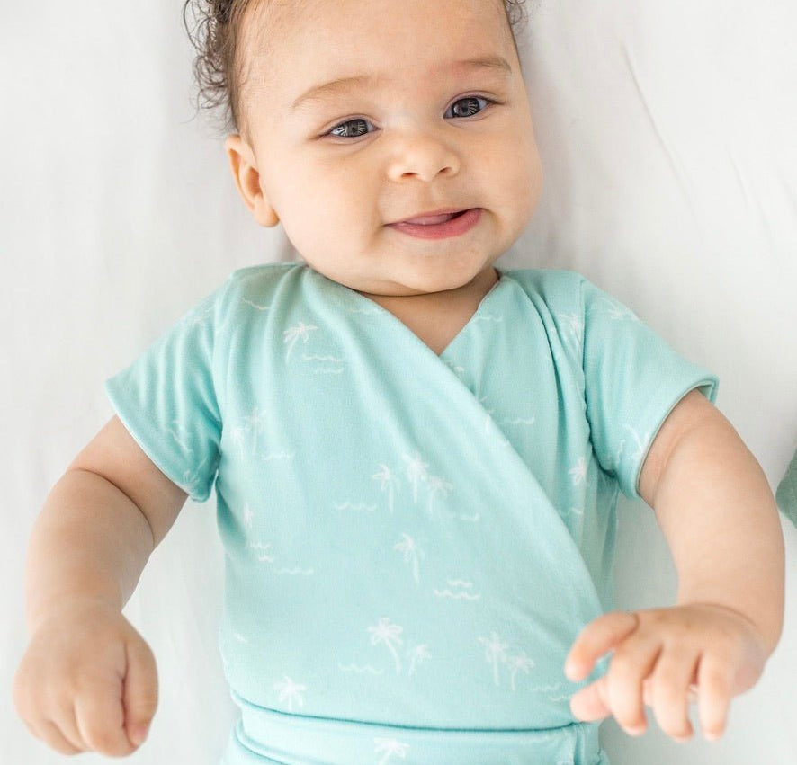 Short-sleeve winged bodysuit featuring the Honeydew Palms print in cozy classic brushed fabric.